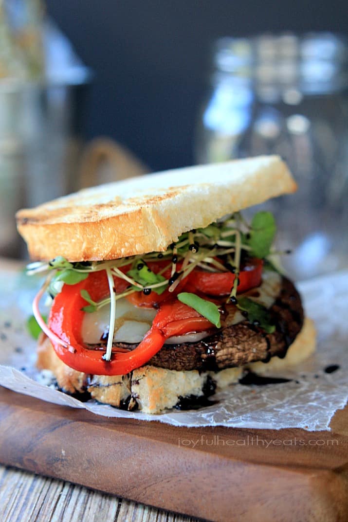 Grilled Portobello Burgers with cheese, red pepper and sprouts on toasted bread