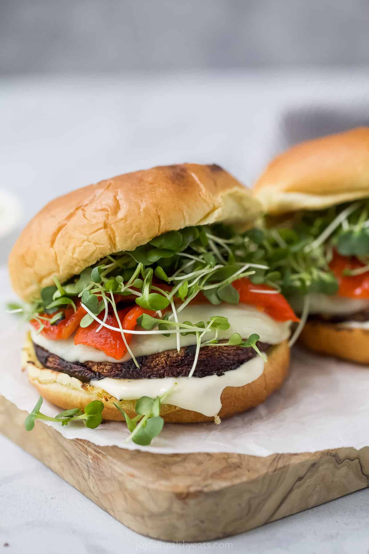 Melti provolone, roasted red pepper and creamy trafle IOli, it can only be the best portobelo mushroom sandwich! Grilled Portobelo Mushroom Sandwich on Wooden Boards