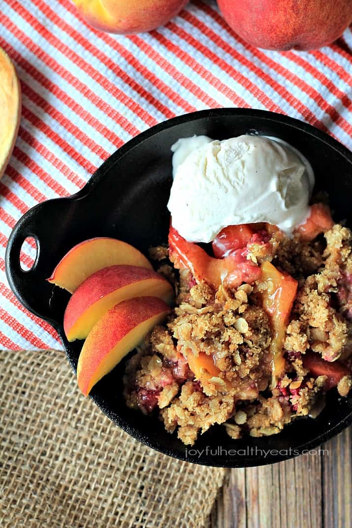 A sweet homemade Raspberry Peach Cobbler for two made with fresh raspberries, peaches, and hints of cinnamon topped with an Crunchy Oatmeal Pecan Crumble. | joyfulhealthyeats.com #recipes