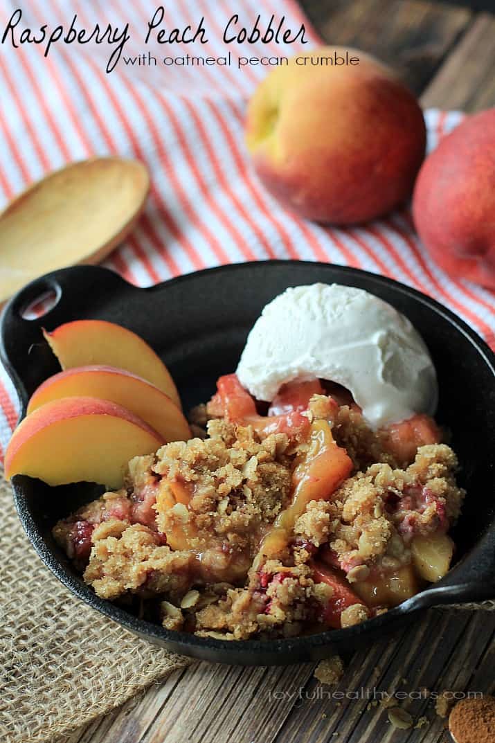 A sweet homemade Raspberry Peach Cobbler for two made with fresh raspberries, peaches, and hints of cinnamon topped with an Crunchy Oatmeal Pecan Crumble. | joyfulhealthyeats.com #recipes