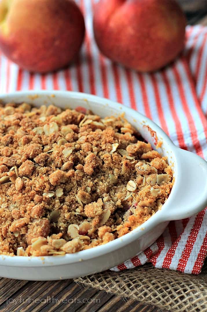 A sweet homemade Raspberry Peach Cobbler for two made with fresh raspberries, peaches, and hints of cinnamon topped with an Crunchy Oatmeal Pecan Crumble. | joyfulhealthyeats.com #recipes