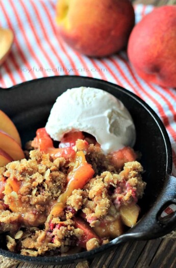 A sweet homemade Raspberry Peach Cobbler for two made with fresh raspberries, peaches, and hints of cinnamon topped with an Crunchy Oatmeal Pecan Crumble. | joyfulhealthyeats.com #recipes