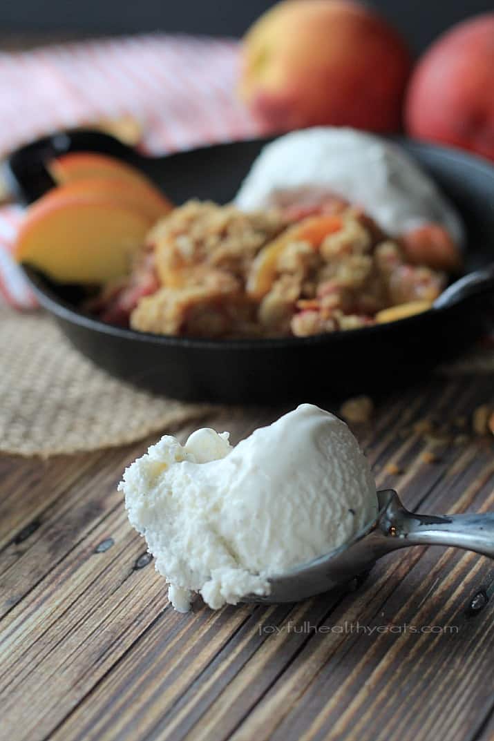 A sweet homemade Raspberry Peach Cobbler for two made with fresh raspberries, peaches, and hints of cinnamon topped with an Crunchy Oatmeal Pecan Crumble. | joyfulhealthyeats.com #recipes