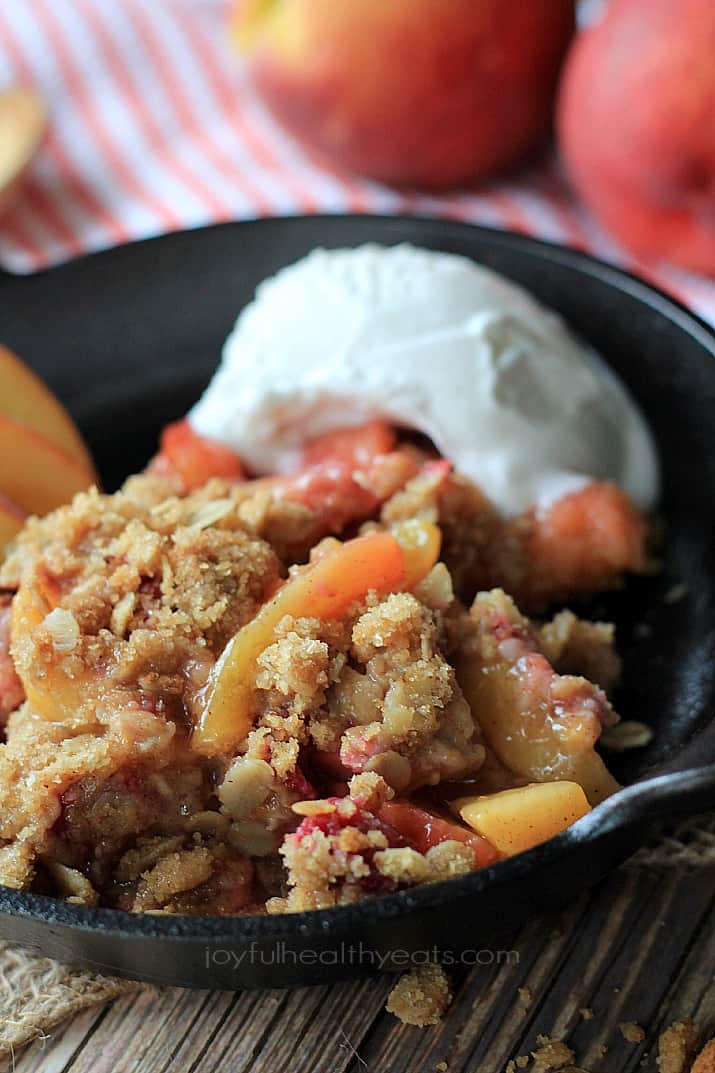 A sweet homemade Raspberry Peach Cobbler for two made with fresh raspberries, peaches, and hints of cinnamon topped with an Crunchy Oatmeal Pecan Crumble. | joyfulhealthyeats.com #recipes