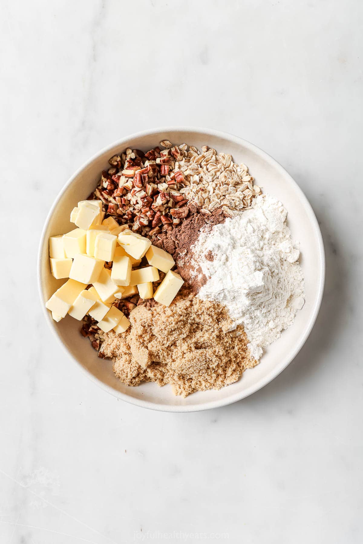 Crunch Oatmeal Pekan Charm. A simple summer sweet! Overhead view of material for crisp topping in the bowl