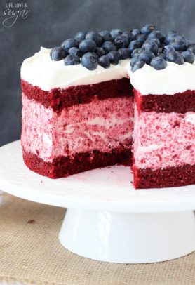 Red Velvet Ice Cream cake on a pedastal stand topped with blueberries
