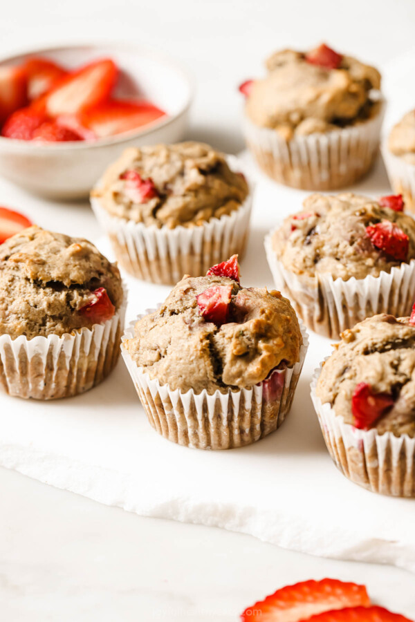Freshly baked strawberry banana muffins on the counter.