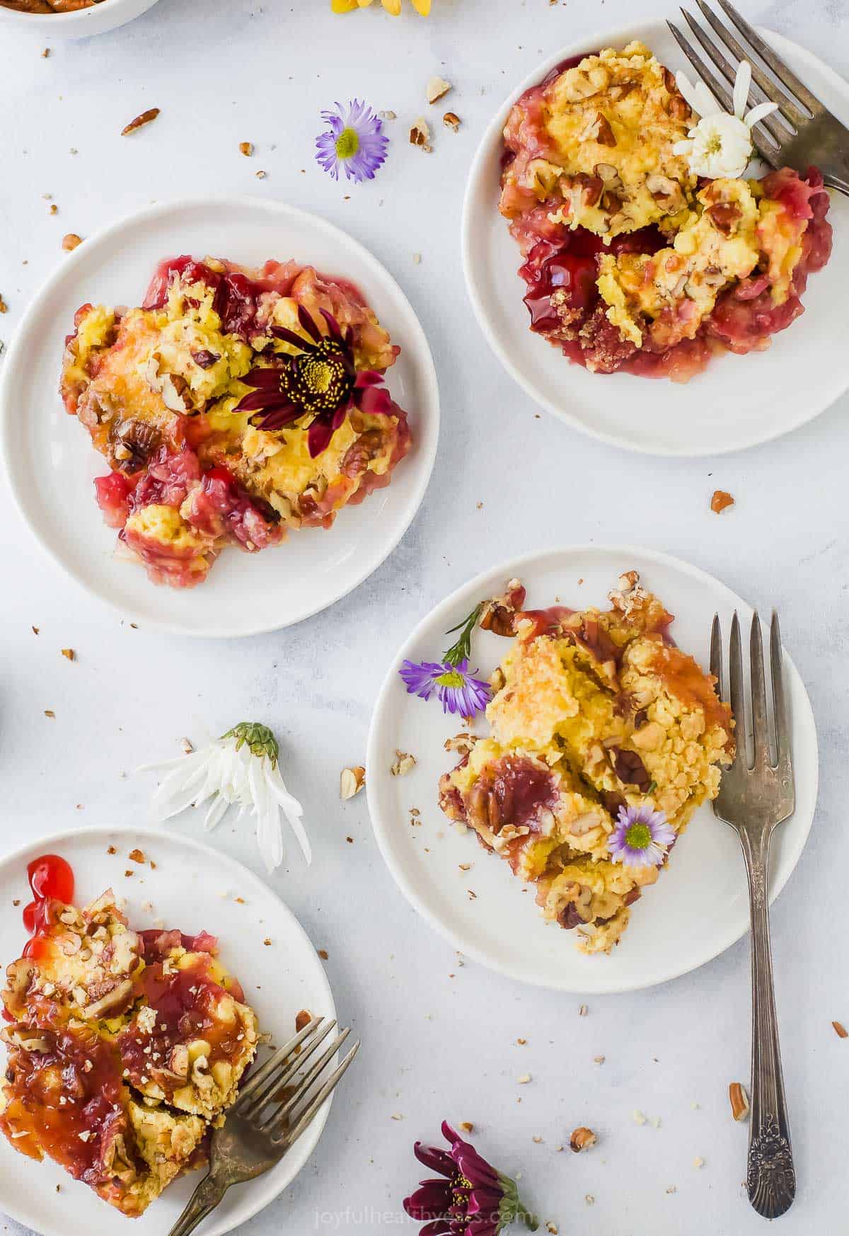 four plates with pineapple cherry dump cake