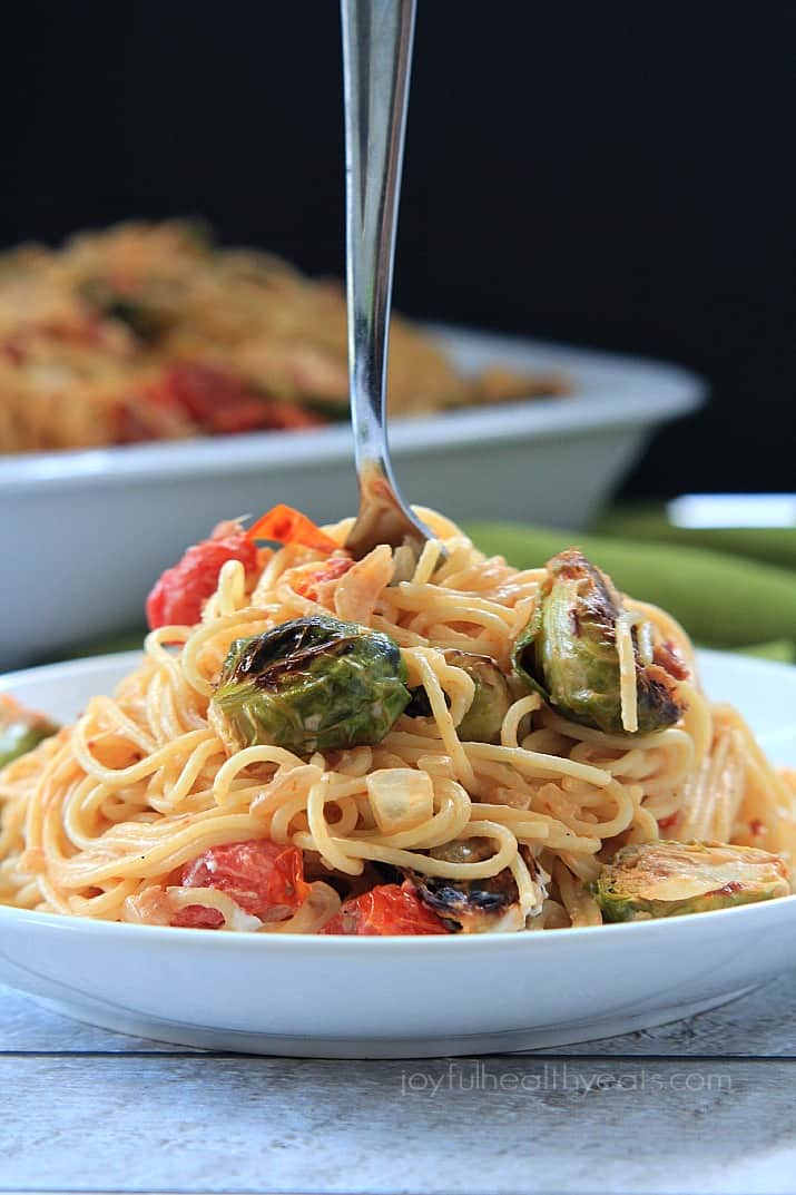 Caramelized Brussels Sprouts Pancetta Pasta with Creamy Goat Cheese Sauce on a plate with a fork