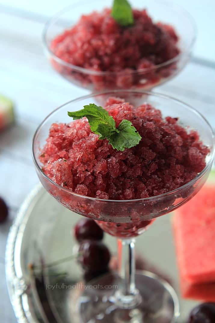 Two dessert glasses of Cherry Watermelon Granita garnished with mint