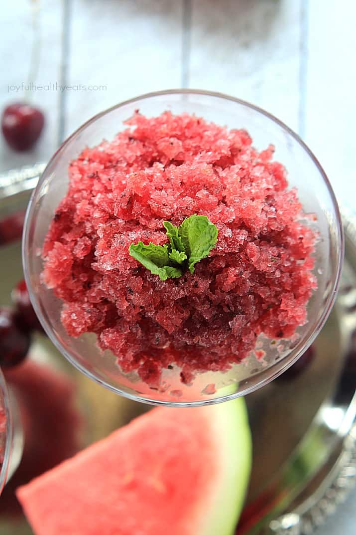 Top view of Cherry Watermelon Granita with a sprig of mint in a dessert glass