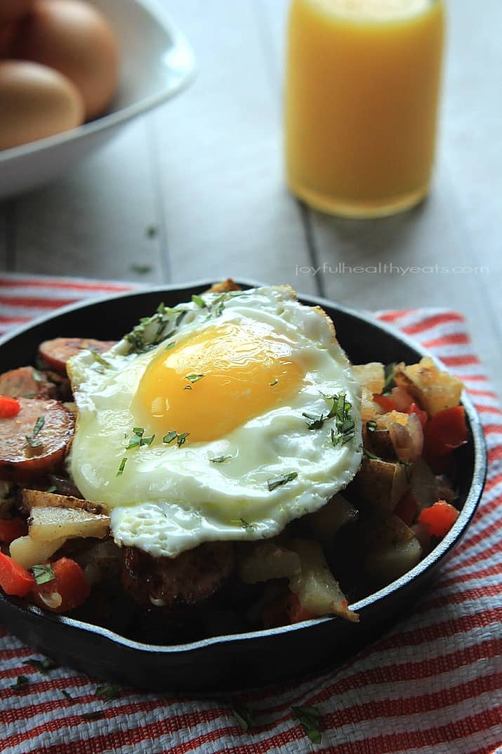 Chicken Sausage Potato Hash in a cast-iron skillet topped with a fried egg