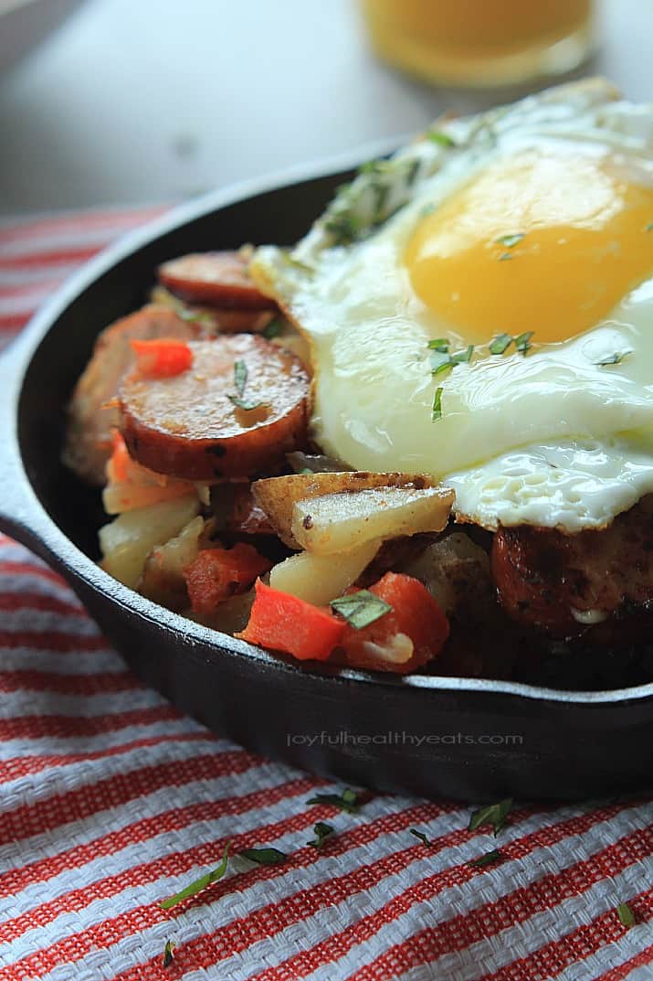 Chicken Sausage Potato Hash in a cast-iron skillet topped with a fried egg