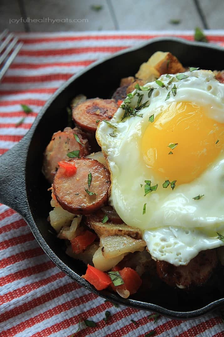 Chicken Sausage Potato Hash in a cast-iron skillet topped with a fried egg