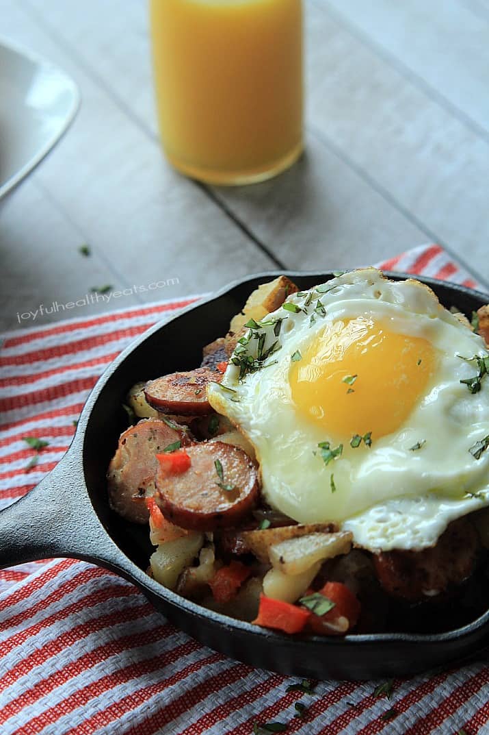 Chicken Sausage Potato Hash in a cast-iron skillet topped with a fried egg