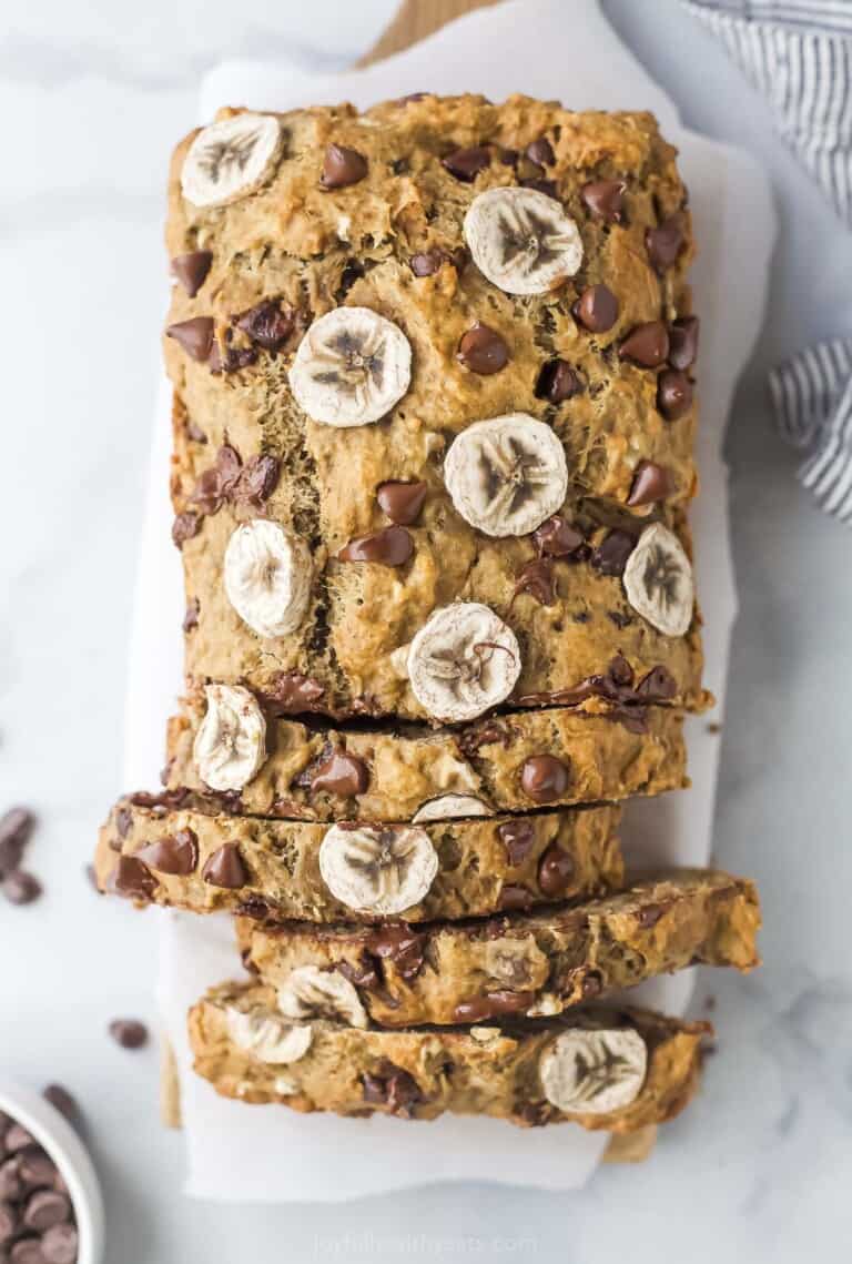 Whole loaf of banana chocolate chip bread. Half of it is sliced.