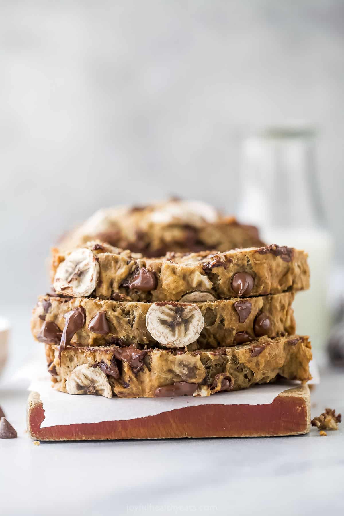 Slices of banana chocolate chip bread stacked on top of one another. 