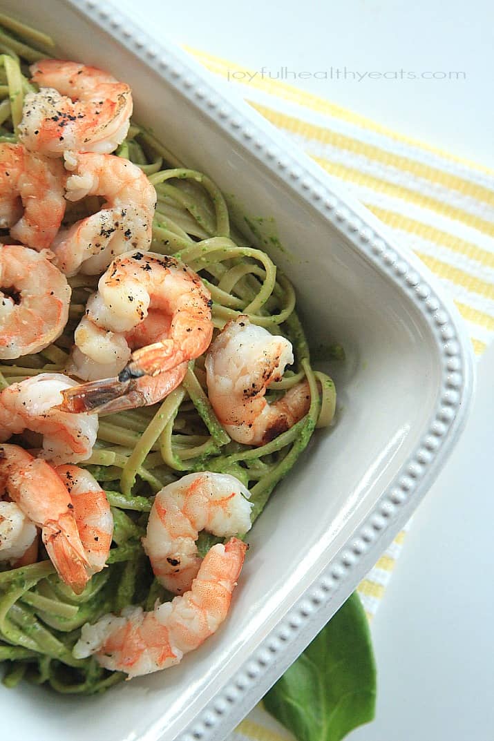 Top view of Goat Cheese Spinach Pesto Pasta with Grilled Shrimp in a serving dish