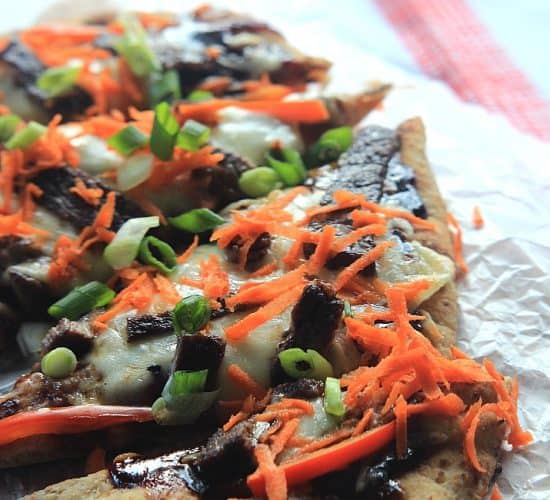 A Grilled Pizza Topped with Veggies on a Piece of Crinkly Wax Paper