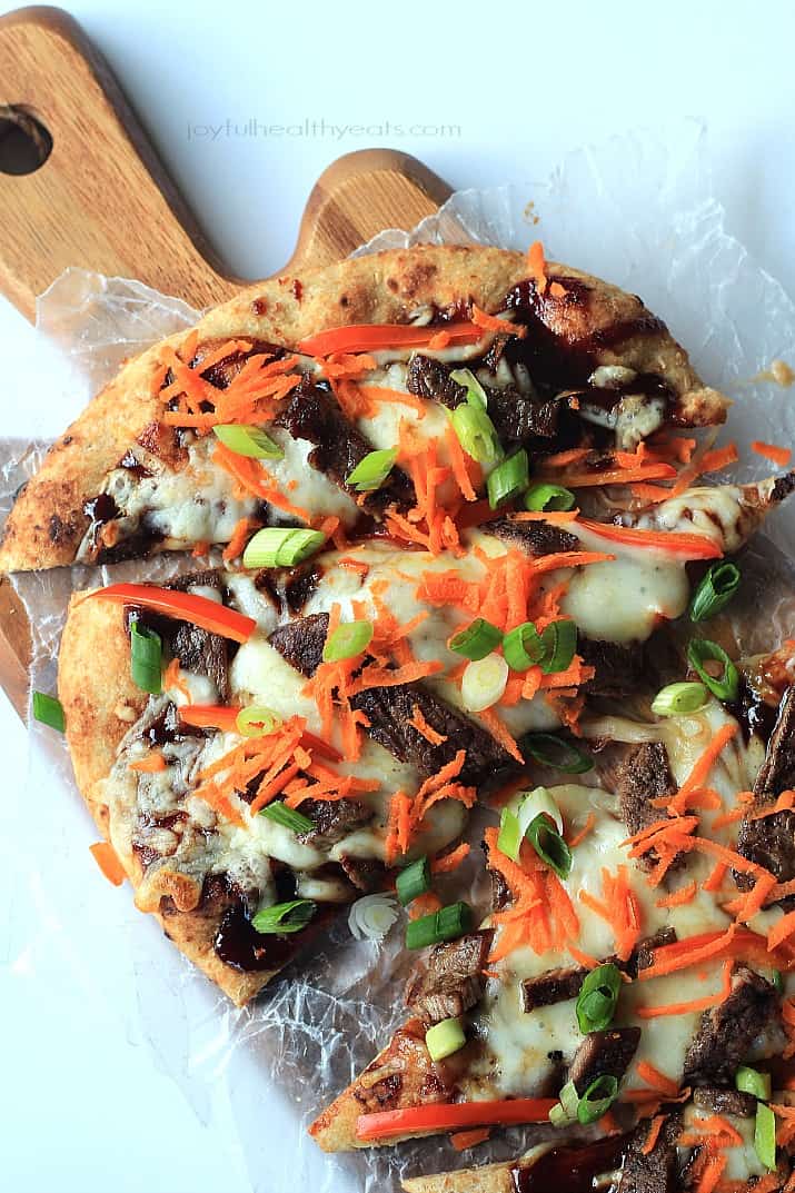 A Grilled Flatbread on Top of a Wooden Cutting Board