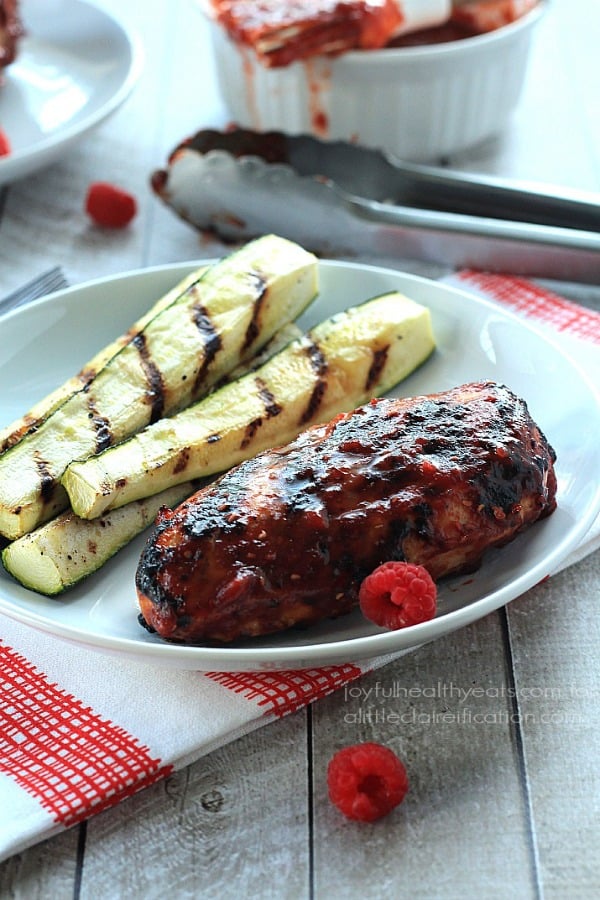 A Plate of Grilled Chipotle Chicken Next to Four Grilled Zucchini Strips