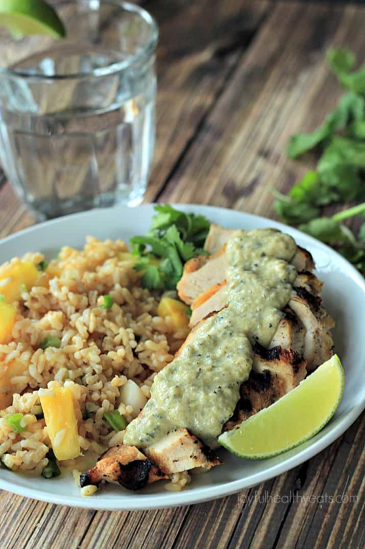 Grilled Chicken with Tomatillo Roasted Poblano Cream Sauce and rice with pineapple on a plate