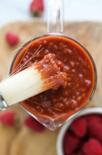 Close-up of a brush with fruity BBQ sauce.