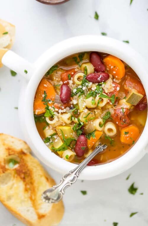 close up of minestrone soup in a soup crock