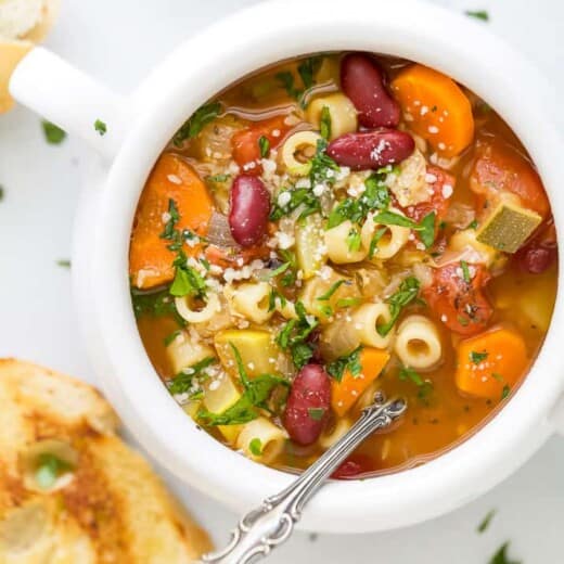 close up of minestrone soup in a soup crock