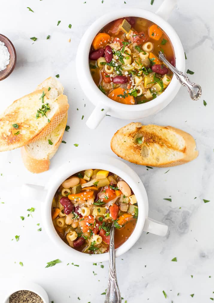 two crocks filled with easy minestrone soup and toasted bread on the side