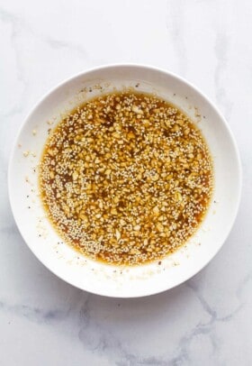 A bowl with ingredients to make sesame ginger dressing.