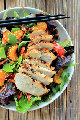 A Bowl of Asian Chicken Salad with Sesame Ginger Dressing and a Pair of Chopsticks