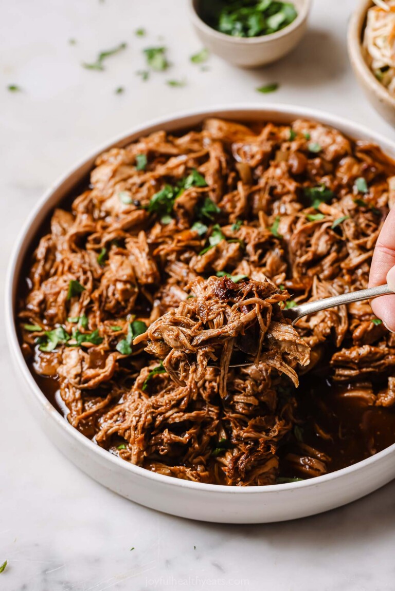 Grabbing some saucy pulled pork with a fork.