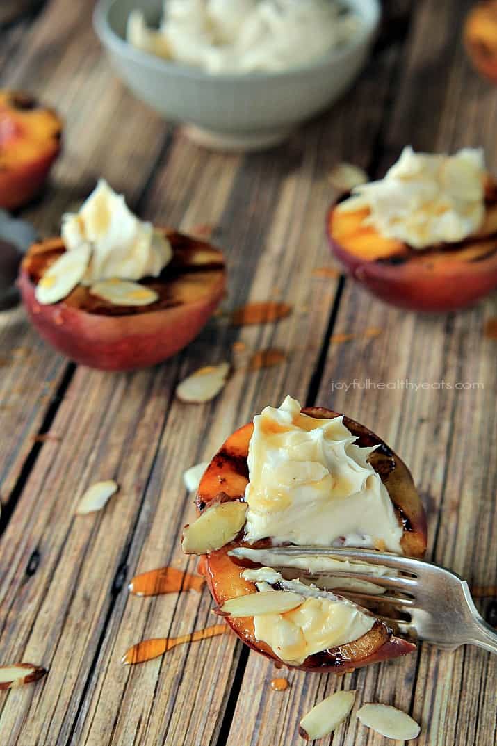 A fork cutting into Grilled Peaches with Maple Honey Mascarpone Cheese