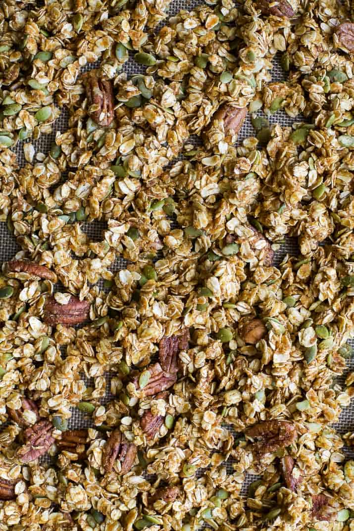 An easy healthy and Homemade Pumpkin Spice Granola Recipe you'll want to indulge on year round! All your favorite fall flavors in one granola recipe - pumpkin, allspice, nutmeg, cloves, cinnamon ... its fall in a bite! Only 190 calories a serving!