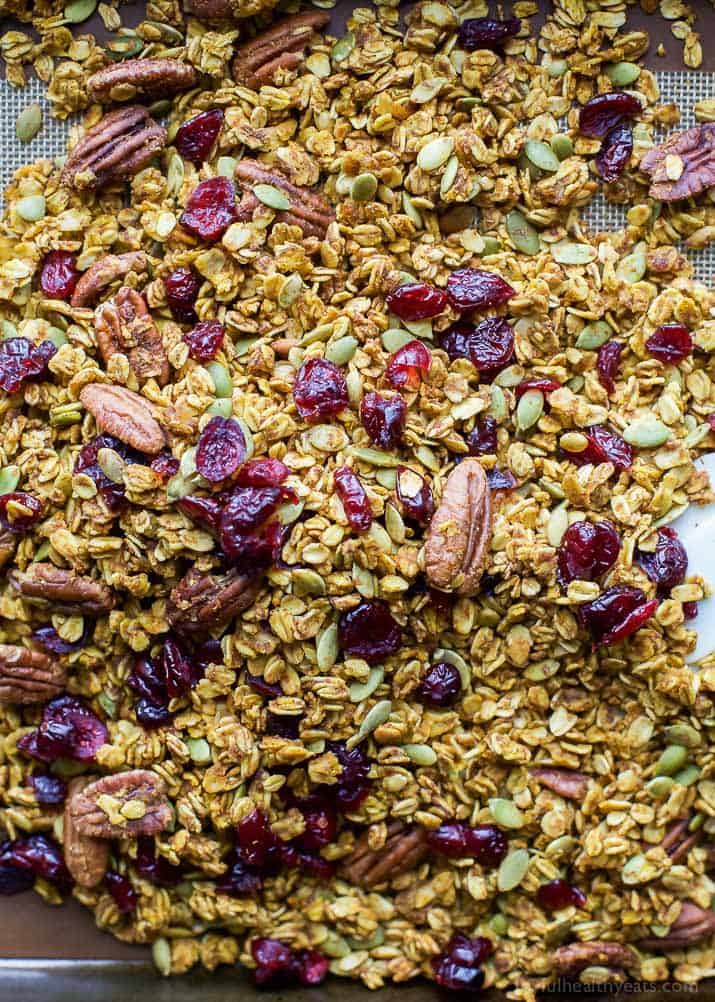 An easy healthy and Homemade Pumpkin Spice Granola Recipe you'll want to indulge on year round! All your favorite fall flavors in one granola recipe - pumpkin, allspice, nutmeg, cloves, cinnamon ... its fall in a bite! Only 190 calories a serving!