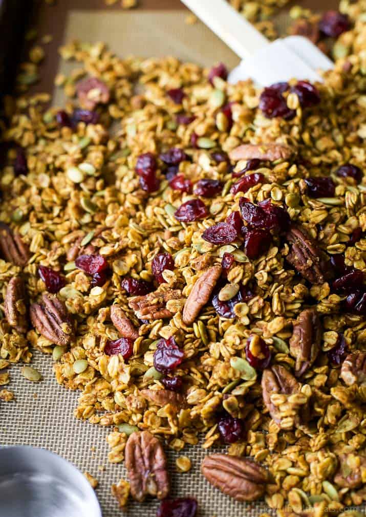 An easy healthy and Homemade Pumpkin Spice Granola Recipe you'll want to indulge on year round! All your favorite fall flavors in one granola recipe - pumpkin, allspice, nutmeg, cloves, cinnamon ... its fall in a bite! Only 190 calories a serving!