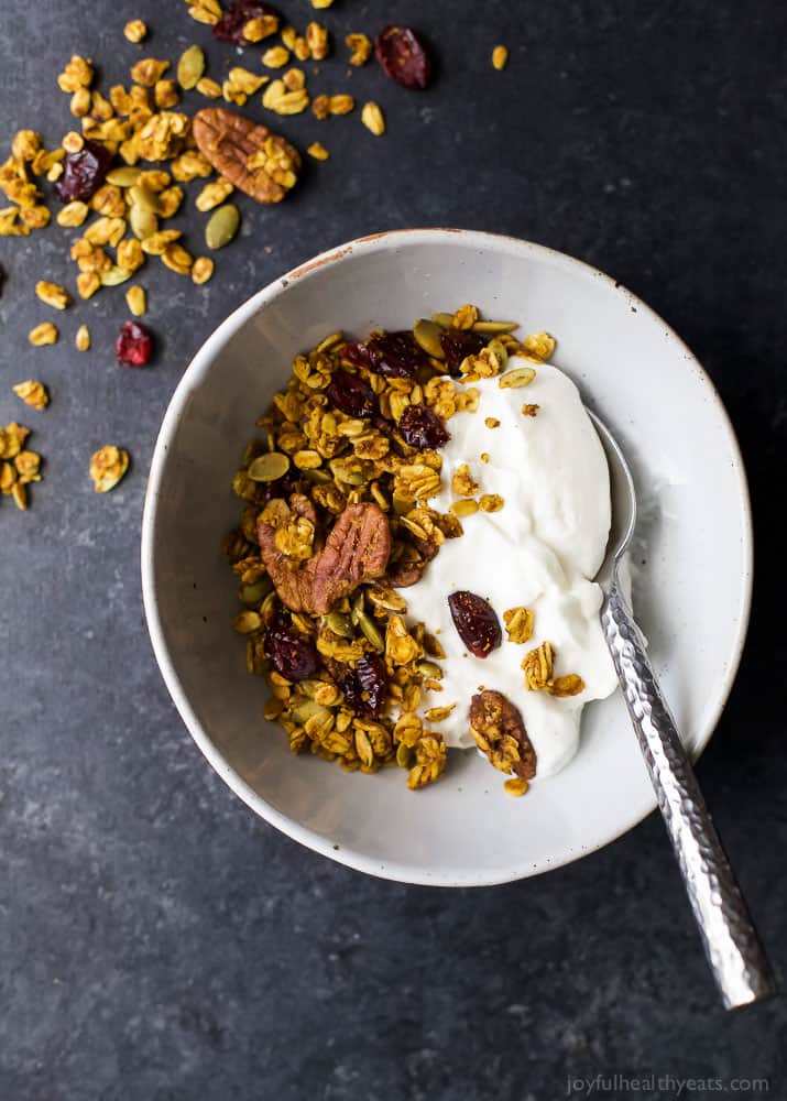 An easy healthy and Homemade Pumpkin Spice Granola Recipe you'll want to indulge on year round! All your favorite fall flavors in one granola recipe - pumpkin, allspice, nutmeg, cloves, cinnamon ... its fall in a bite! Only 190 calories a serving!