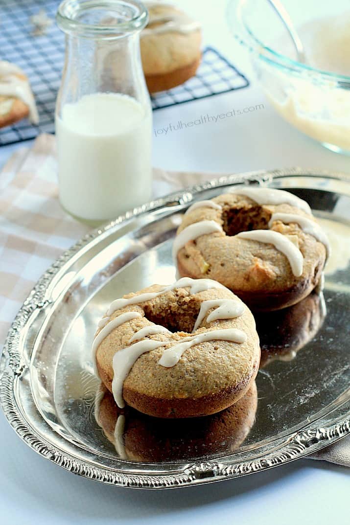 Baked Apple Donuts with a Cardamom Cream Cheese Glaze on a silver plate