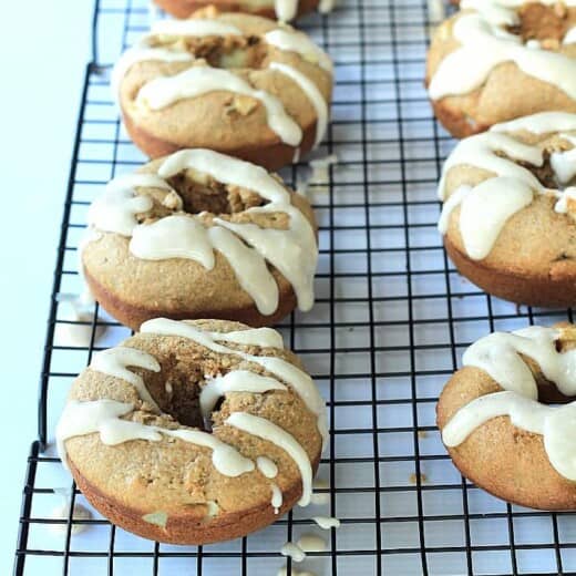 A healthier version of donuts for the fall! Baked Apple Donuts with a Cardamom Cream Cheese Glaze | www.joyfulhealthyeats.com #fallrecipes #applerecipes