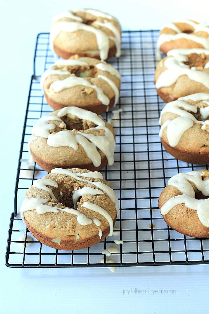 Baked Apple Donuts with a Cardamom Cream Cheese Glaze on a cooling rack