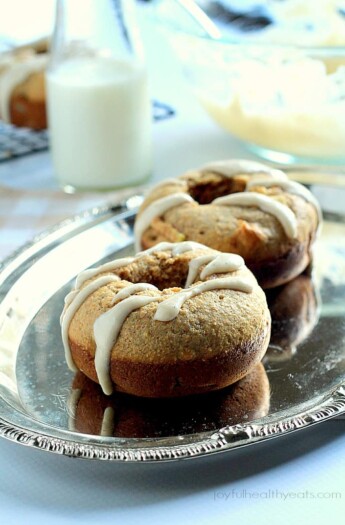 A healthier version of donuts for the fall! Baked Apple Donuts with a Cardamom Cream Cheese Glaze | www.joyfulhealthyeats.com #fallrecipes #applerecipes