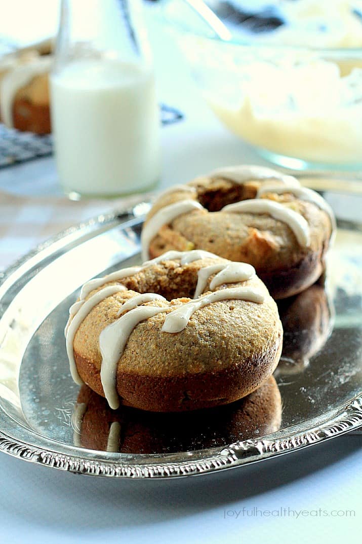 Baked Apple Donuts with a Cardamom Cream Cheese Glaze on a platter