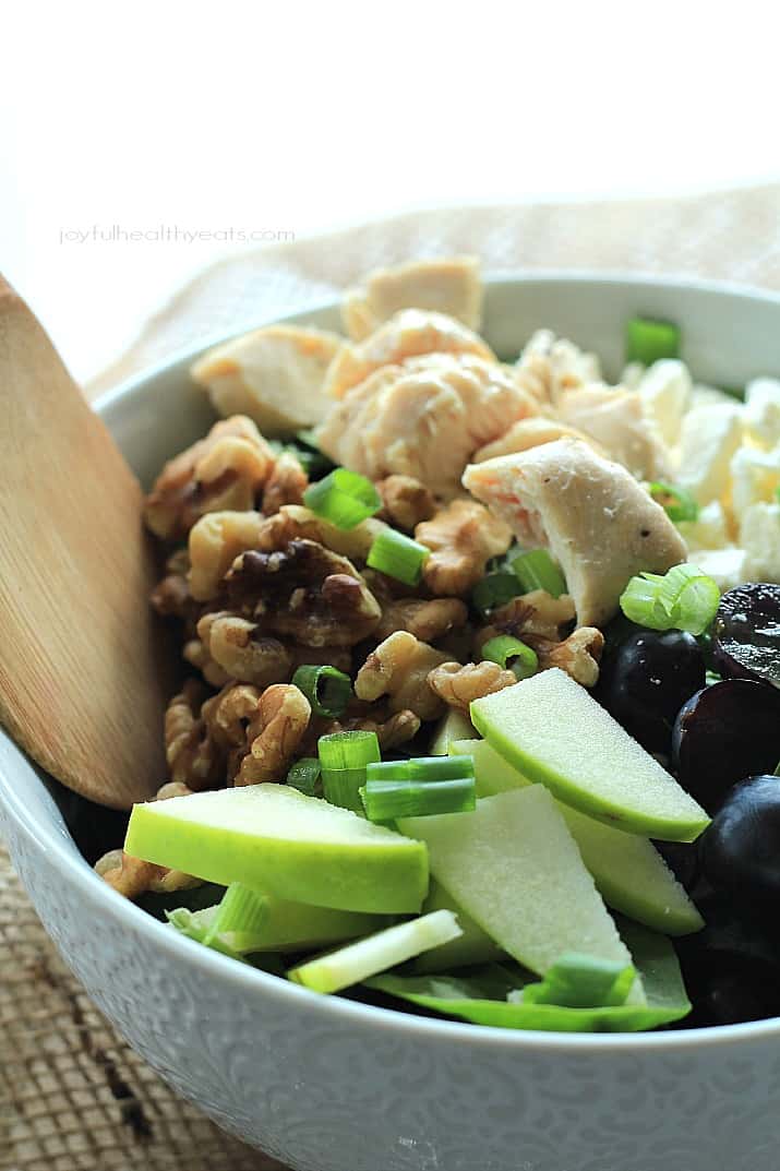 A Chopped Salad in a Bowl with Walnuts, Chicken and Green Apple Slices