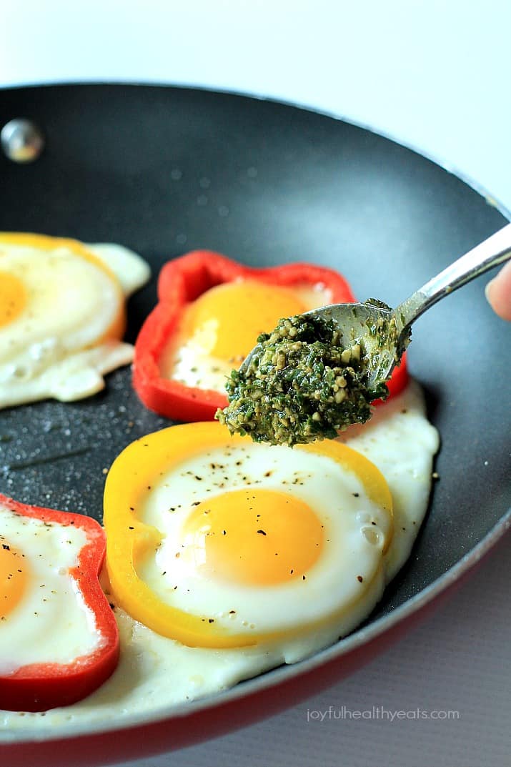 Egg in a Hole with Basil Pesto and bell pepper rings in a skillet
