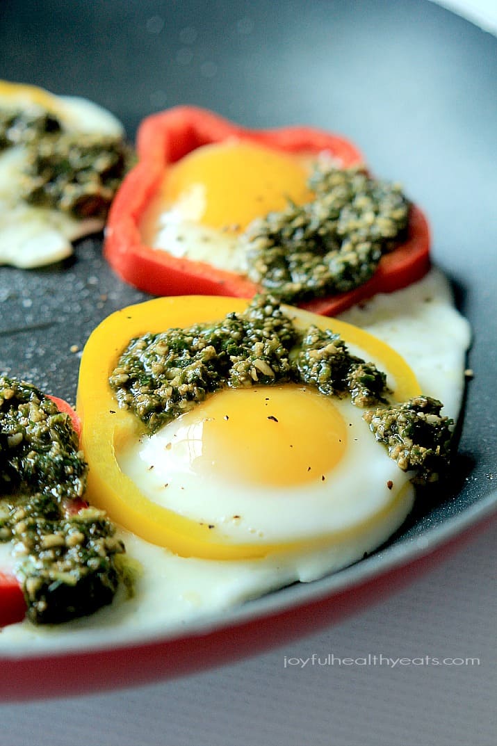 Egg in a Hole with Basil Pesto and bell pepper rings in a skillet