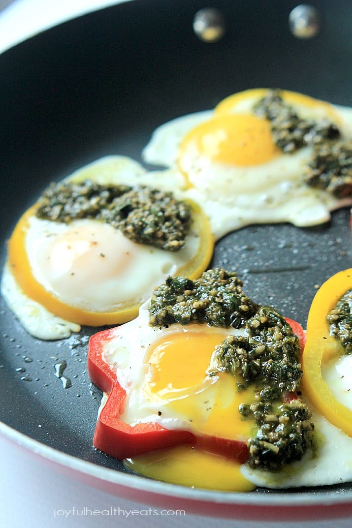 Egg in a Hole with Basil Pesto and bell pepper rings in a skillet