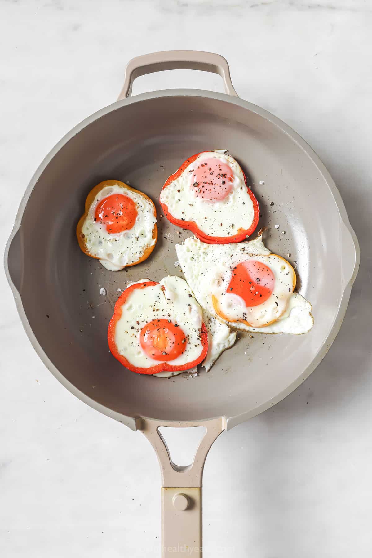 Over-easy eggs in each bell pepper ring.