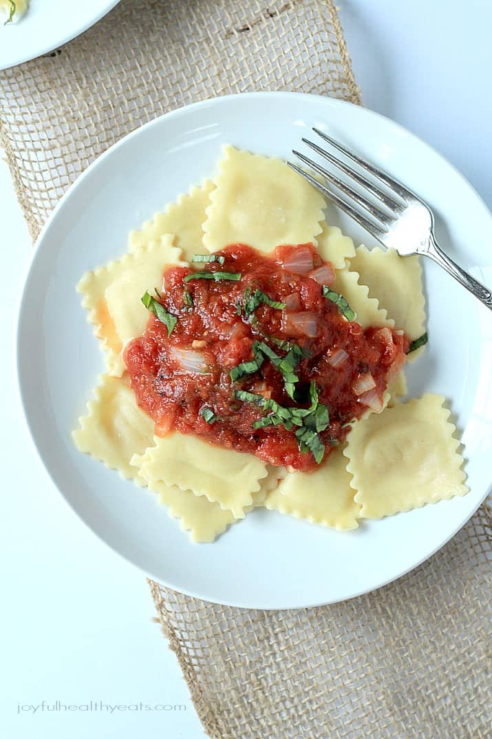 Top view of Four Cheese Ravioli with Homemade Marinara Sauce on a plate