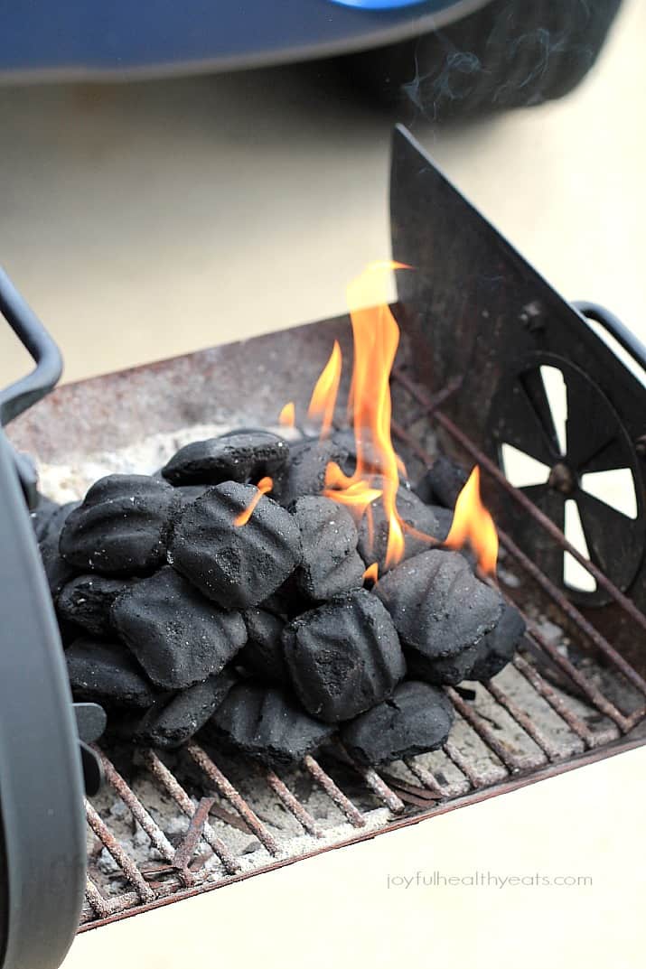Flaming charcoal briquettes on a grill